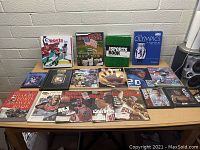 Wide view of table showing assortment of sports books and binders with Chicago Bulls and Sports Illustrated themes