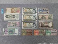Image shows a collection of 15 foreign paper currency notes of various denominations from Canada, Vietnam, and other countries. Notes vary widely in color, design, and condition.