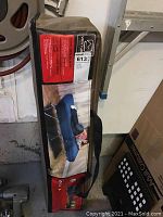 Carrying bag for the air bed with product image showing setup of twin bed in a bag with two people lying on it.