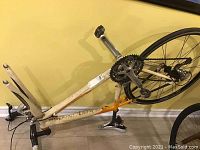 Side view of bike frame showing rear wheel, crankset and missing front wheel