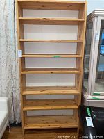 Front view of tall 6-shelf natural wood bookshelf showing all shelves and natural wood grain.