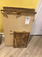 Photo of the rectangular wooden carving board showing natural grain and decorative inlay with utensils and Hebrew text