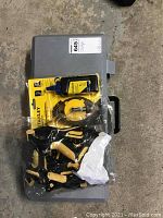 Photo showing gray plastic carrying case with Maxtech clamps and Stanley chalk line kit on top