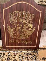Exterior of dart board cabinet showing 'Kings Head Pub & Lodging' design on front.