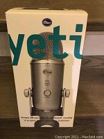 Front of Blue Yeti microphone box showing a silver USB microphone with logo and large text 'yeti'.
