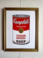 Front view of Andy Warhol lithograph artwork framed in a gold frame showing the Campbell's Chicken Noodle Soup can graphic.