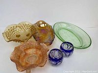 All items grouped showing apricot bubble glass pedestal bowl, carnival glass bowls, green glass dish, cobalt etched glasses