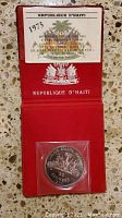 Full view of the coin in original red case with certificate on top