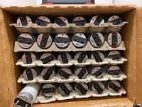 Box showing 30 white fluorescent tubes stacked in cardboard with bi-pin ends visible.