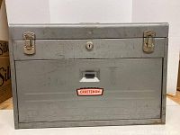 Front view of gray metal Craftsman toolbox with logo, showing size and condition