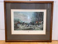 Full frontal image of framed wall art print showing horse riders and hounds in outdoor setting.
