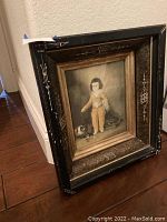 Framed print leaning against wall showing the full artwork and exterior frame.