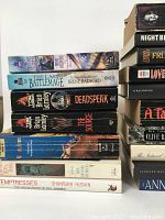 Stack of various Gothic, fantasy, and dark fiction books showing titles by Anne Rice, Brian Lumley, Irene Radford, and others.