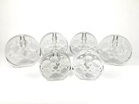 Front view of six clear glass candle holders arranged in two rows, with visible bubble patterns inside the glass body.