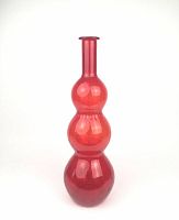 Full view of the mid-century rubi red hand blown glass vase showing its full triple-bulb form and narrow neck.