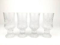 Four clear textured wine glasses arranged side by side showing the unique raised pattern on glass surfaces.