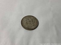Obverse side of 1882 Morgan Silver Dollar coin showing Lady Liberty profile with stars.
