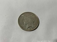 Obverse of 1923 Peace Silver Dollar showing Lady Liberty with radiate crown and inscriptions.