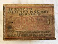 Top view of the branded wooden box lid showing text and graphics for Mother Ann Brand Gorton Salt Codfish from Gorton Pew Fisheries Gloucester Mass.
