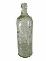 Front view showing embossed text: 'MOXIE NERVE FOOD LOWELL MASS. PATENTED' on green-tinted glass bottle.