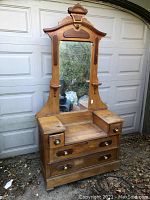 Full front view of oak drop well dresser vanity showing mirror, drawers, candle shelves and hardware