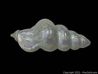 Side view of the white carnival glass spiral shell showing iridescent surface and smooth spiral shape.