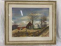 Framed watercolor painting showing a rural farmhouse, barn, trees, and fence under a cloudy sky