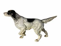 Cast iron pointer dog doorstop showing side profile with wear on paint and black and white color pattern.
