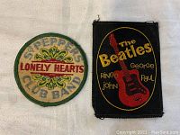 Front view of both patches on fabric background showing design details