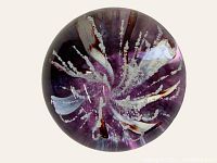 Top view of the Selkirk Glass Space Orchid paperweight showing purple and white floral design with inner bubbles and detailed petals.