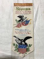 Front side of the woven souvenir ribbon featuring eagles, American flags and exposition text