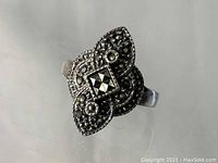 Close-up photo of vintage sterling silver ring with marcasite stones showing top design and detailing.