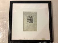 Framed wood engraving print showing the full piece within black frame and white matte.