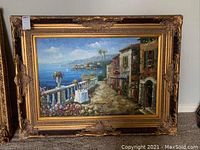 Full frontal view of the framed painting leaning against a wall.