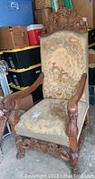 Front view of the carved wooden chair with upholstered seat and back