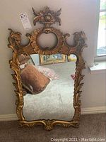 Full front view of rectangular mirror leaning against wall