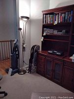 Full view showing floor lamp next to folding chairs and wooden furniture