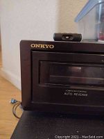 Front-left view showing Onkyo branding and computer control auto reverse text on cassette tape window panel.