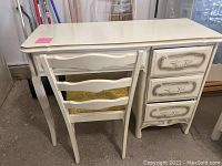 Front view of vintage cream desk with matching chair placed in front