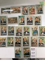 Full laid out view of all 24 cards showing front color portraits of presidents and historical scenes, each in hard plastic case, organized in rows.