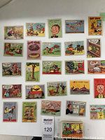 Top-down photo showing many of the joke postcards laid out in a grid pattern. Cards display colorful cartoons and various jokes in comic style, with wear and creases visible.