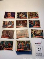 Image showing multiple trading cards from the Robin Hood set arranged on a white surface. Visible cards include scenes titled: Strange Welcome, Pay Or Else, Call The Guards, I Demand Justice, Ready For Battle, Flashing Swords, The Holdup, and others.