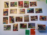 Photo showing 20 of the trivia cards with question text and colorful illustrations, laid out on a white background.