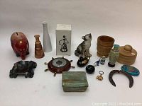 Photo showing assortment of 18 vintage decorative items arranged in group on white surface