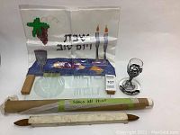 The full lot showing the spread cloth, silver candle holder, wooden base, and two fabric scrolls.