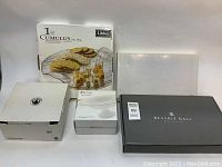 Four boxed serving items include Libbey Cumulus plate box, Beatriz Ball box, and two additional white boxes.