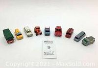 All nine Lesney die cast toy vehicles arranged in a row, showing variety in type and paint colors with visible wear.