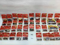 Wide view of all 41 sealed Majorette vehicles arranged in rows