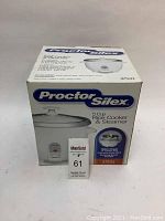 Front and top view of the Proctor Silex 5 Cup Rice Cooker & Steamer box indicating model number 37531 and features, showing unopened packaging and branding.