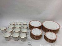 Full display of Royal Worcester dish set with grouped plates of various sizes and multiple cups, highlighting 63 total pieces.